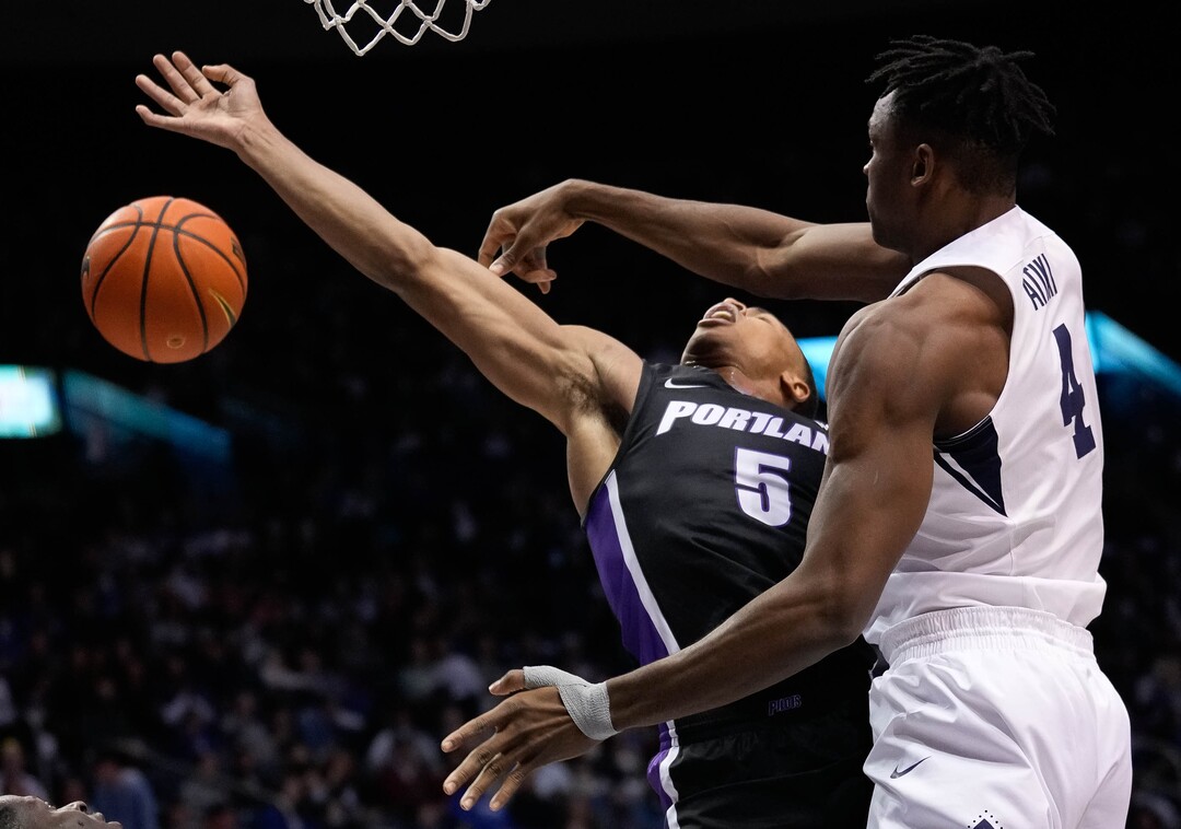 (Francisco Kjolseth | The Salt Lake Tribune) Brigham Young Cougars forward Atiki Ally Atiki (4) puts the block on Portland Pilots guard Chris Austin (5) in WCC basketball action between the Brigham Young Cougars and the Portland Pilots, at the Marriott Center, on Saturday, January 22, 2022.