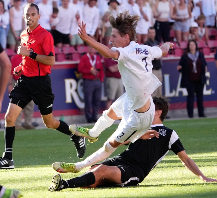 (Francisco Kjolseth | The Salt Lake Tribune) Herriman's Trevor Walk (7) goes down over Davis's Luke Bitner (3) during their 6A State Soccer Championship title game at Rio Tinto Stadium, Wednesday, May 25, 2022. Herriman defeated Davis 1-0 with two seconds left on the clock.