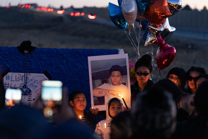 (Francisco Kjolseth | The Salt Lake Tribune) More that a hundred people gather at the candlelight vigil of Hunter High football players Paul Tahi , 15, Tivani Lopati, 14, and Ephraim Asiata, 15, on Friday, Jan 14, 2022, in West Valley City, near Hunter High School along 1400 South at Mountain View Corridor. Paul Tahi and Tivani Lopati were killed in a shooting, while Ephraim Asiata remains in critical condition.