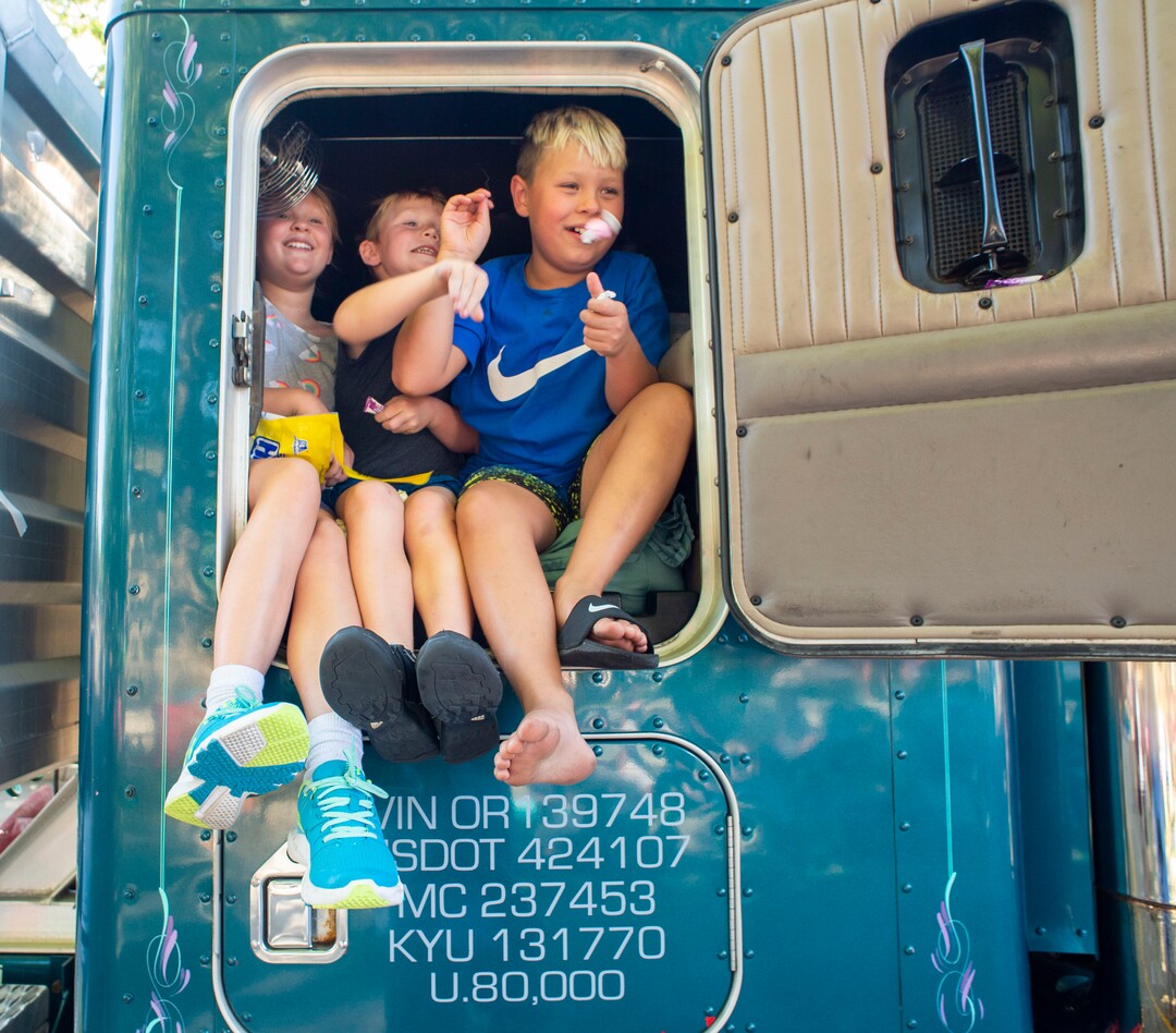 (Rick Egan  |  The Salt Lake Tribune)    Kids toss candy out of the window of a semi-truck in the Bountiful Handcart Days Parade, Friday, July 19, 2019.