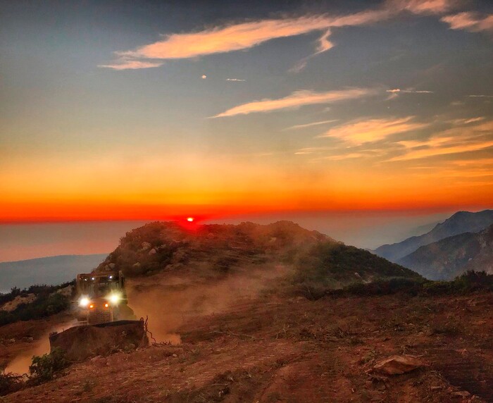 (Mike Eliason | Santa Barbara County Fire Department via AP) In this photo released by Santa Barbara County Fire Department, a dozer from the Santa Barbara County Fire Department clears a fire break across a canyon from atop Camino Cielo down to Gibraltar to make a stand should the fire move in that direction, Wednesday, Dec. 13, 2017, in the Santa Ynez Mountains area of Santa Barbara, Calif. State fire officials predicted Wednesday night that the Thomas Fire northwest of Los Angeles will continue to grow as it eats up parched brush and hot, dry weather continues.