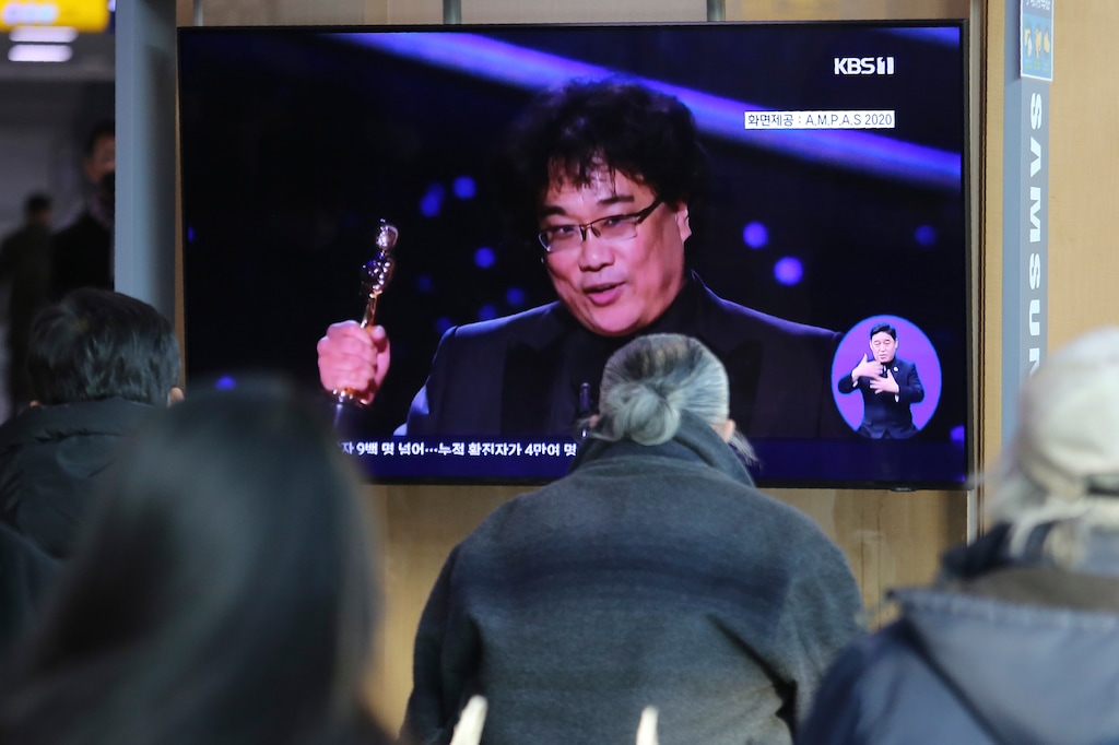 (Ahn Young-joon | AP) People watch a TV screen showing an image of South Korean director Bong Joon Ho during a news program at the Seoul Railway Station in Seoul, South Korea, Monday, Feb. 10, 2020. In a milestone win that instantly expanded the Oscars' horizons, Bong's masterfully devious class satire "Parasite" became the first non-English language film to win best picture in the 92-year history of the Academy Awards.