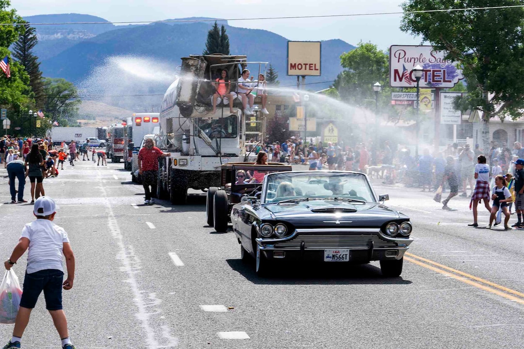 (Rick Egan | The Salt Lake Tribune) 
Water cannons cool down the crowd as the Pioneer Day Parade makes its way down Center Street in Panguitch, on Saturday, July 23, 2022.