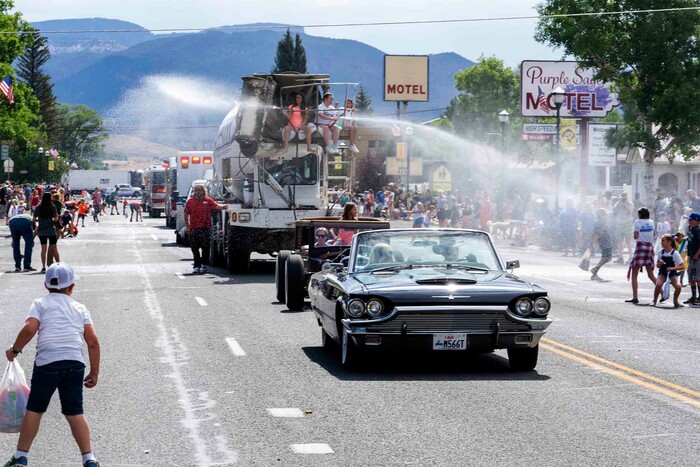 (Rick Egan | The Salt Lake Tribune) 
Water cannons cool down the crowd as the Pioneer Day Parade makes its way down Center Street in Panguitch, on Saturday, July 23, 2022.