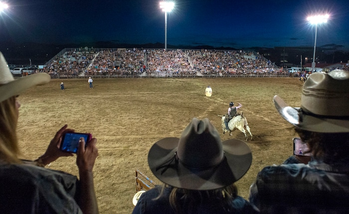 (Rick Egan  |  The Salt Lake Tribune)     Rodeo fans watch the bull riding  competition, at the West Jordan Western Stampede Rodeo, Saturday, July 6, 2019.