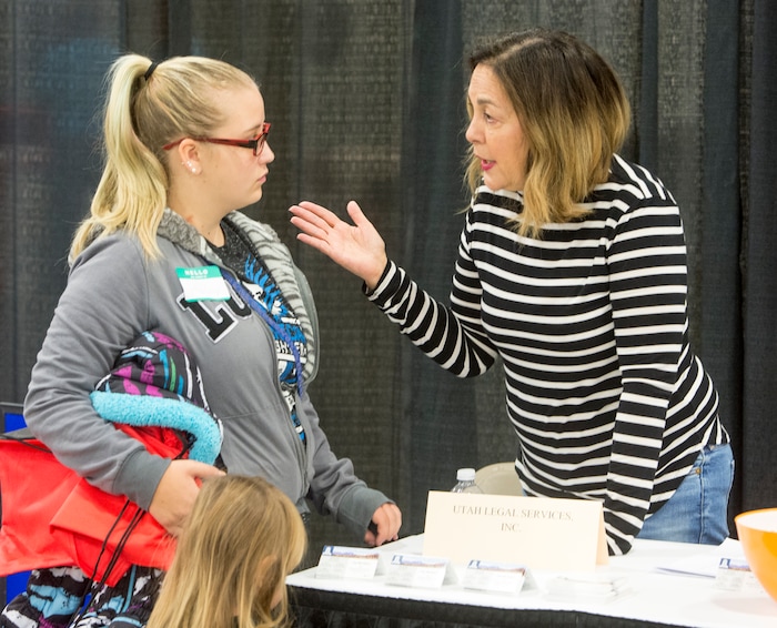 (Rick Egan  |  The Salt Lake Tribune)  Hailey Bartlett, and her 3-year-old daughter Abigail Fletcher talk wait for some legal help from Sylvia Bosen, during Project Homeless Connect,  a one-day, one-stop event in Salt Lake City that brings together community volunteers to provide services for individuals and families experiencing homelessness. Friday, October 6, 2017.