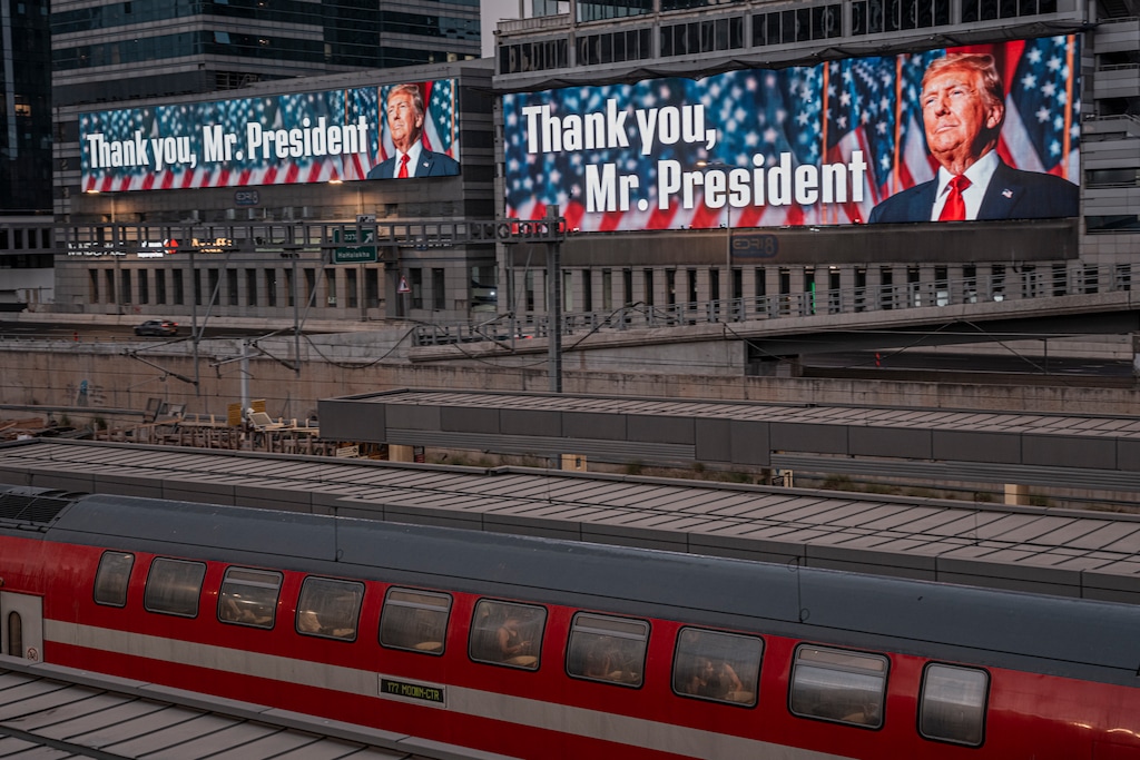(Daniel Berehulak | The New York Times) A passenger train passes near billboards thanking President Donald Trump in central Tel Aviv, Israel, on Sunday, June 22, 2025. Iran fired missiles aimed at an American base in Qatar on Monday, the largest U.S. military installation in the Middle East, according to three Iranian officials with knowledge of the matter.