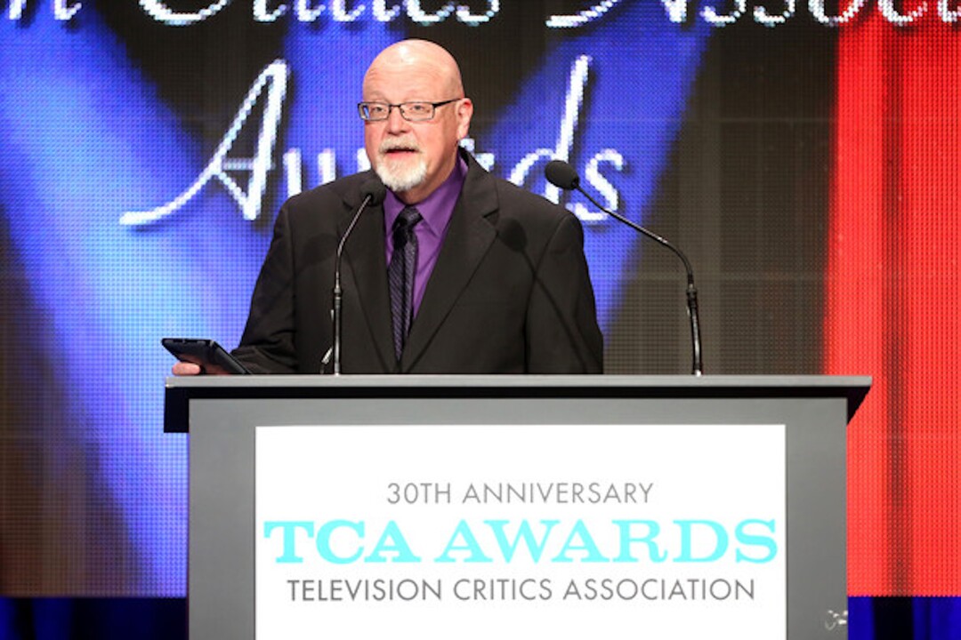 (File photo courtesy of Getty Images) Scott D. Pierce, who was president of the Television Critics Association at the time, welcomes guests to the 2014 TCA Awards. What no one knew at the time was that Miss Piggy (and her handler) were hiding under the podium.