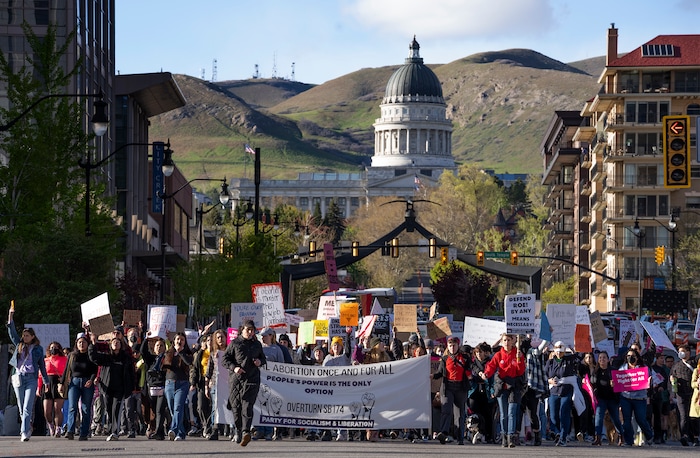 (Rick Egan | The Salt Lake Tribune) Hundreds of protesters march down State Street after a bans off our bodies protest hosted by Planned Parenthood, on Tuesday, May 3, 2022.
