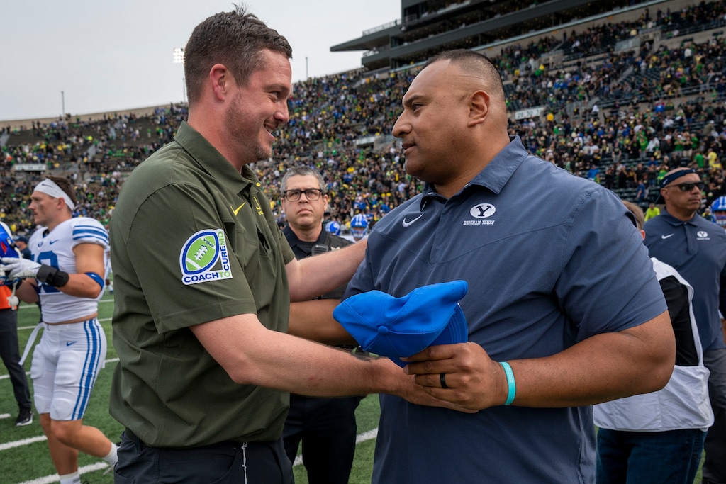 (Andy Nelson | AP) Oregon head coach Dan Lanning, left, and BYU head coach Kalani Sitake meet after an NCAA college football game Saturday, Sept. 17, 2022, in Eugene, Ore.