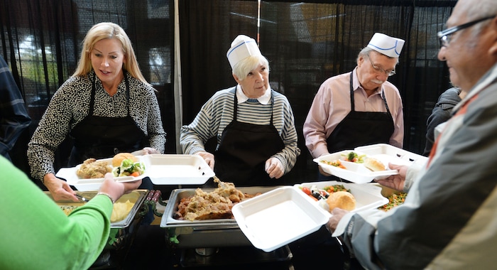 Steve Griffin  |  The Salt Lake Tribune

Tammy Sloan, left, Gail Miller and her husband Kim Wilson serve food during the 17th annual ÒWe Care Ñ We ShareÓ Thanksgiving Dinner for local homeless and low-income individuals at Vivint Smart Home Arena in Salt Lake City Monday, November 16, 2015. The annual event is part of the NBA Cares Season of Giving. 