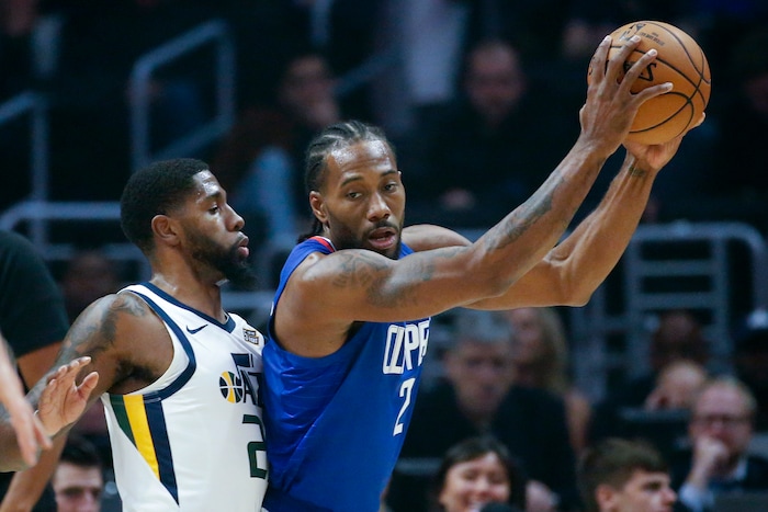 Los Angeles Clippers' Kawhi Leonard (2) is defended by Utah Jazz's Royce O'Neale (23) during the first half of an NBA basketball game Sunday, Nov. 3, 2019, in Los Angeles. (AP Photo/Ringo H.W. Chiu)