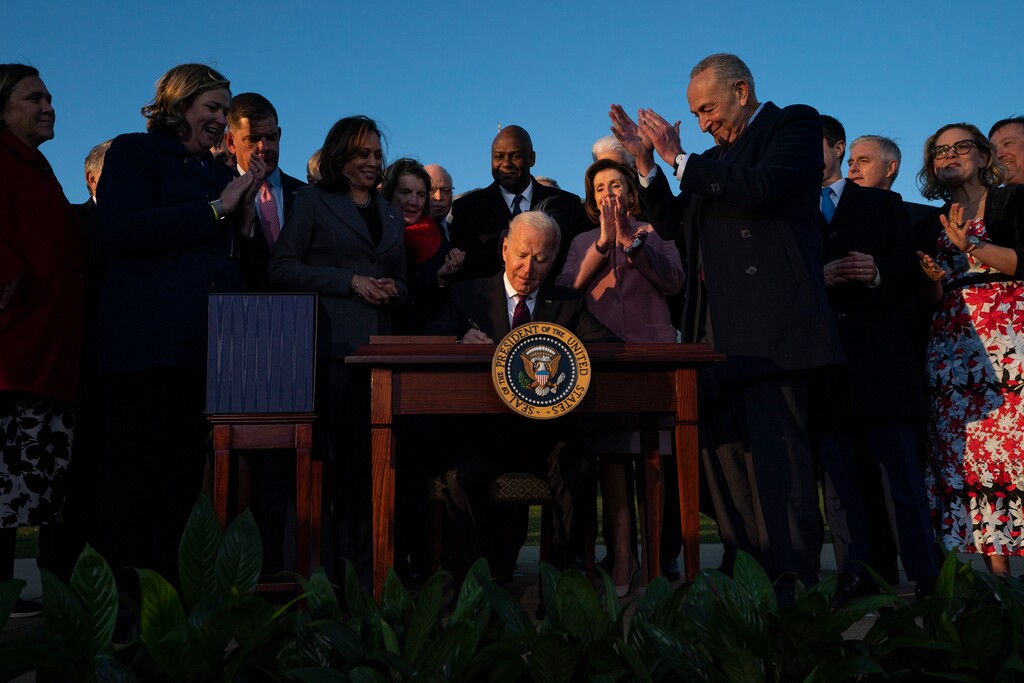 (Evan Vucci | AP) President Joe Biden signs the "Infrastructure Investment and Jobs Act" during an event on the South Lawn of the White House, Monday, Nov. 15, 2021, in Washington.