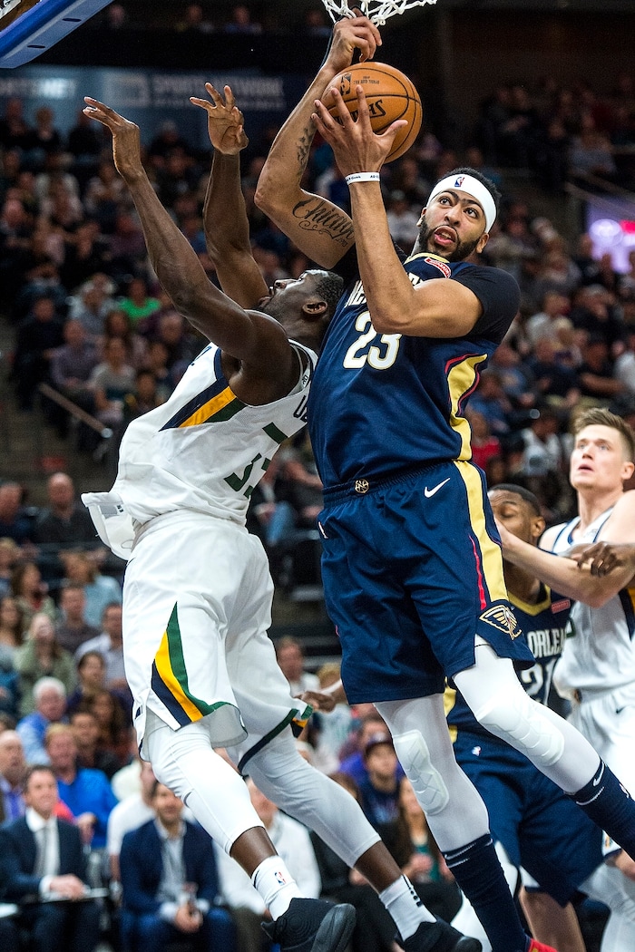 (Chris Detrick  |  The Salt Lake Tribune)  New Orleans Pelicans forward Anthony Davis (23) grabs a rebound past Utah Jazz center Ekpe Udoh (33) during the game at Vivint Smart Home Arena Friday, December 1, 2017.  