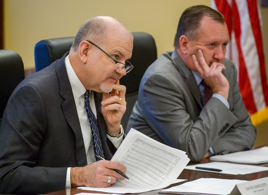 (Leah Hogsten | Tribune file photo) this Nov. 26, 2018, file photo shows State Treasurer David Damschen, left, and State Auditor John Dougall, right, during a Board of Canvassers meeting. Dougall has announced a privacy commission to review the practices and policy of Banjo, a private surveillance company with millions in state contracts. But impending legislative budget cuts that will pull the state out of some or all of these contracts may make the review a moot point.
