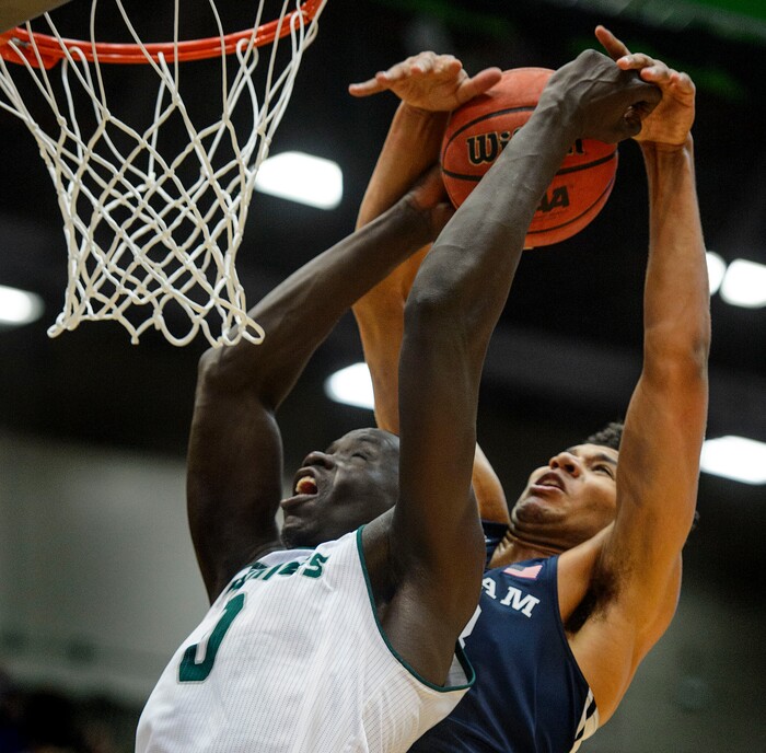 (Steve Griffin  |  The Salt Lake Tribune) Brigham Young Cougars forward Yoeli Childs (23) blocks a dunk attempt by Utah Valley Wolverines center Akolda Manyang (0) during the BYU versus UVU basketball game at UCCU Center on the UVU campus in Orem Wednesday November 29, 2017.