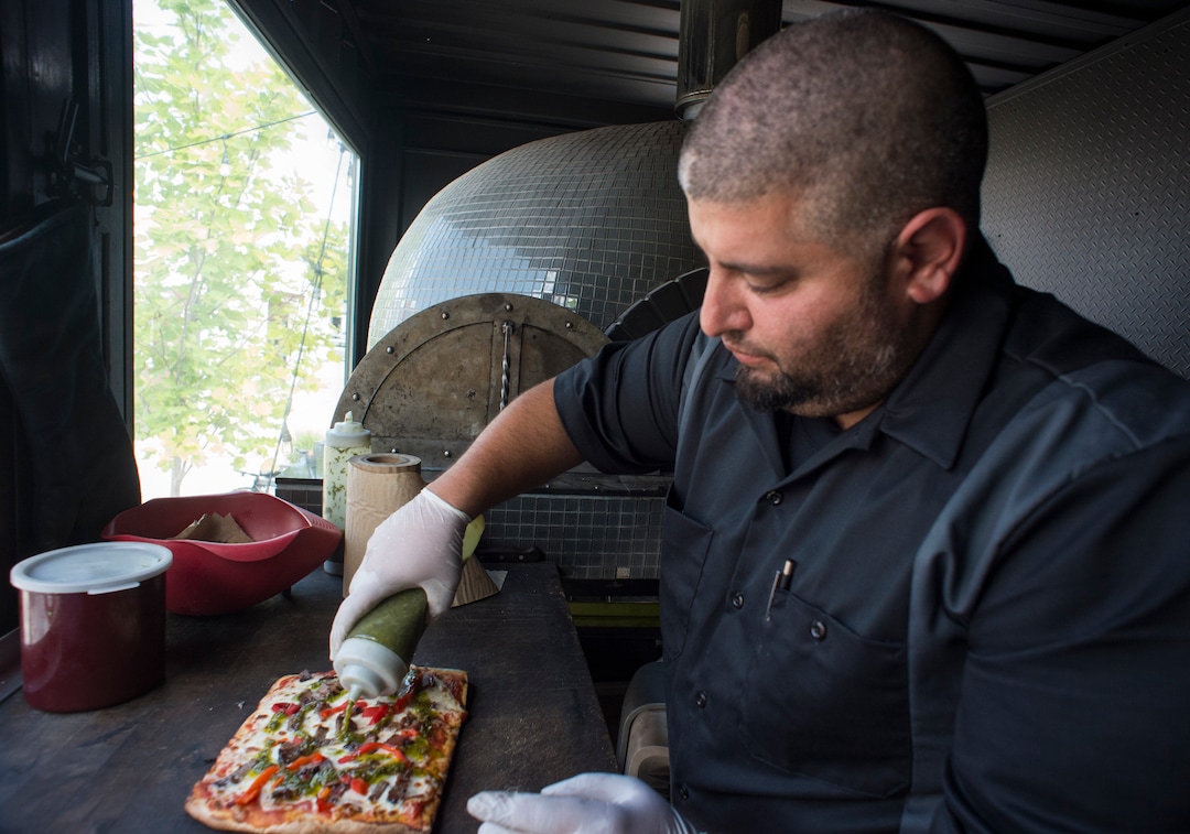 (Rick Egan  |  The Salt Lake Tribune) Fabio Marsenro prepares the Criolla pizza with smoked beef brisket, red peppers with homemade chimichurri sauce in the Umani food truck.