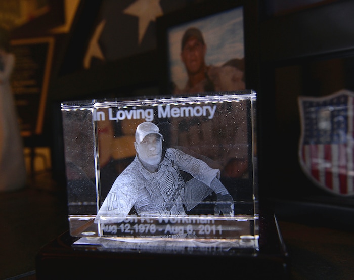 Al Hartmann  |  The Salt Lake Tribune 
Three dimensional glass engraved image of Jason Workman that sits in Betty and Rodney Workman's living room in Blanding.   Jason Workman, a member of Seal Team 6 was among 38 military personnel shot down by Taliban fighters in a Chinook helicopter on Aug. 6, 2011. It was the largest loss of U.S. life in the Afghanistan campaign.  Two Utahns were on the helicopter,  Taylorsville's Jared Day and Blanding's Jason Workman. Five years later, family and friends still grapple with their absence while battling to keep alive their memory — Workman, as a big, daring family man with a kind heart and Day as a "goofball" who loved video games and anime and who could make people laugh during times of extreme stress.
The two men shared a birthday, Aug. 12.
