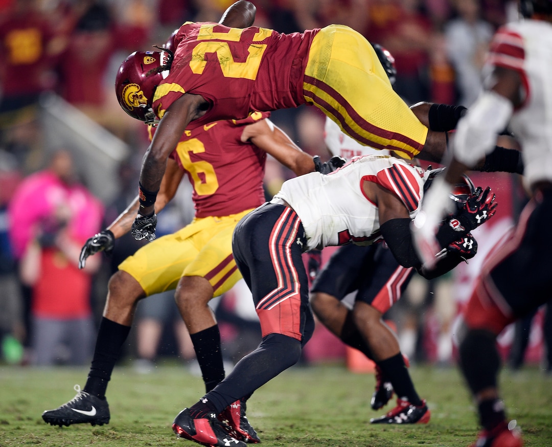 Southern California running back Ronald Jones II, top, jumps over Utah defensive back Marquise Blair to score a touchdown during the second half of an NCAA college football game in Los Angeles, Saturday, Oct. 14, 2017. USC won 28-27. (AP Photo/Kelvin Kuo)