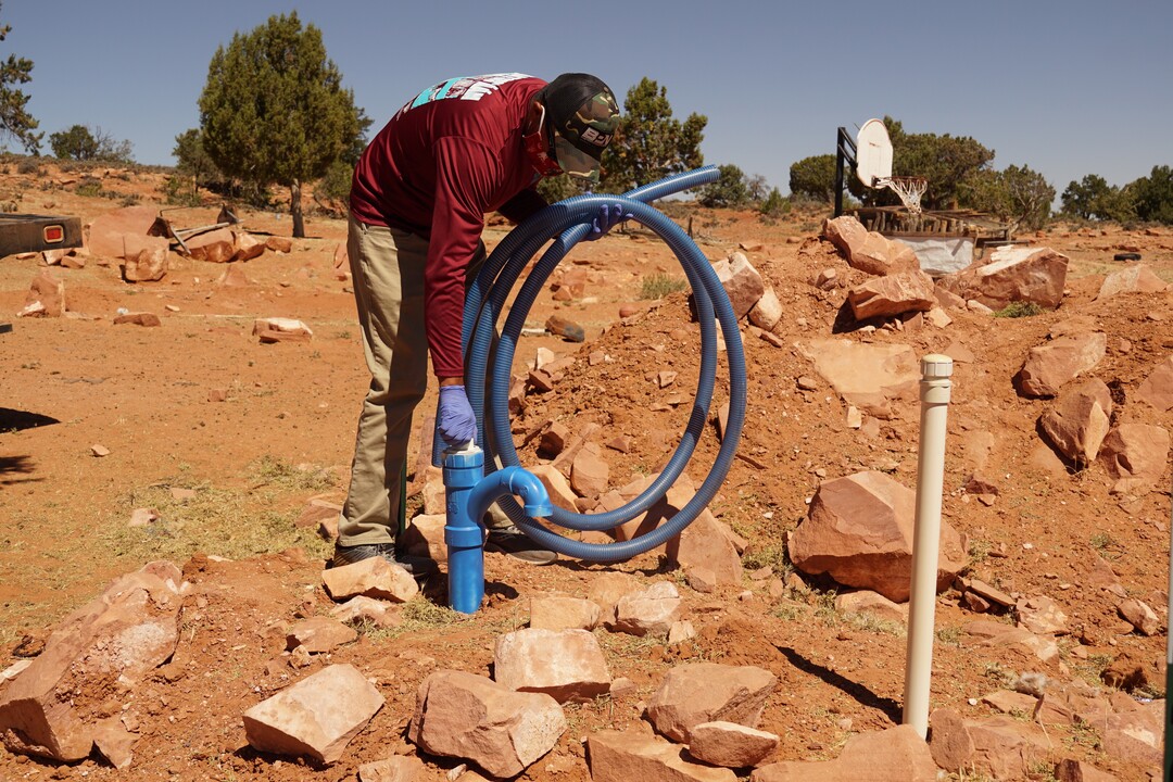 (Zak Podmore | The Salt Lake Tribune) Donovan Smallcanyon, a water and solar technician for DigDeep's Navajo Water Project, fills an underground cistern at a remote home on Piute Mesa on July 1, 2020.