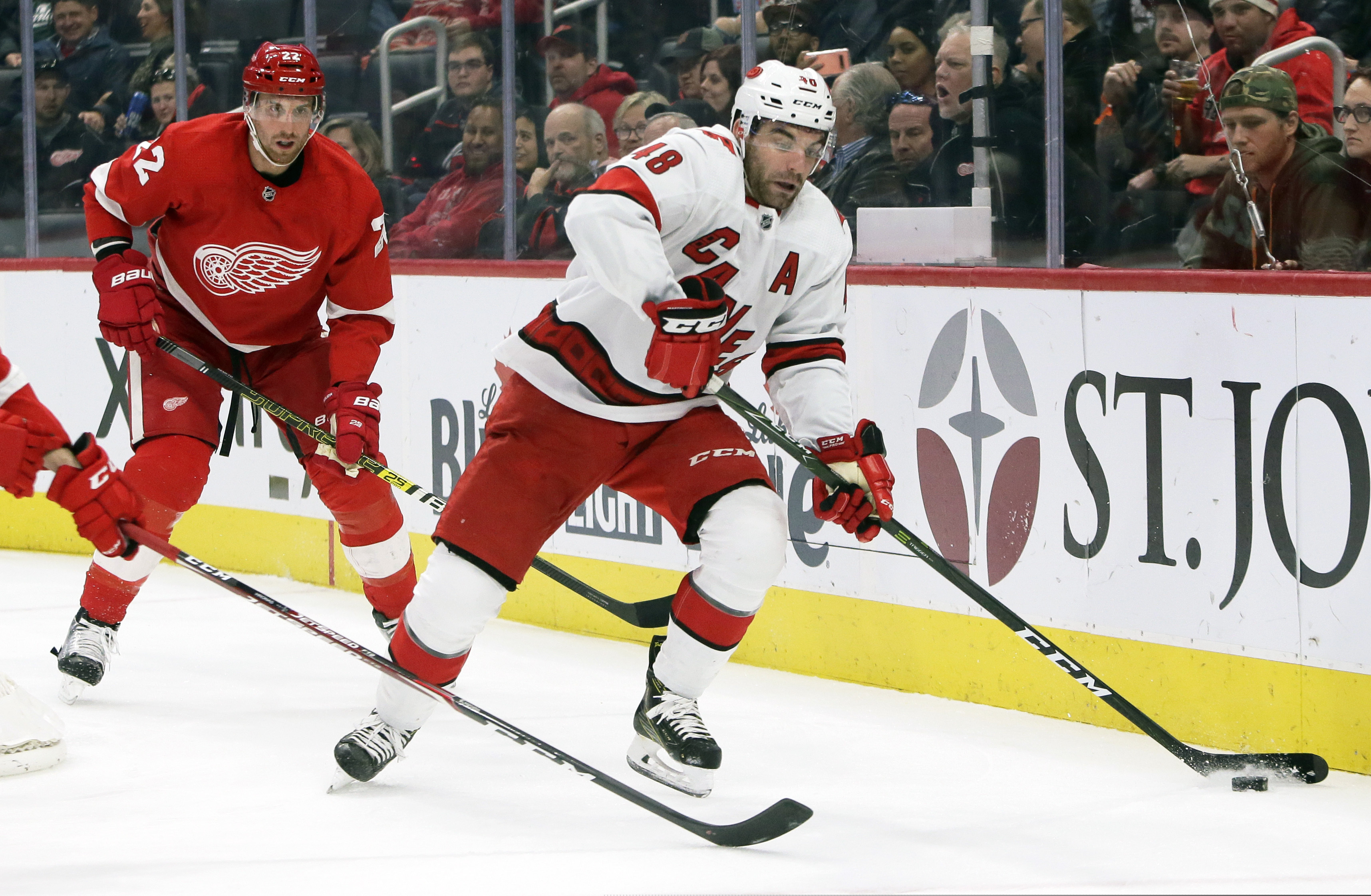 Carolina Hurricanes left wing Jordan Martinook (48) is pursued by Detroit Red Wings defenseman Patrik Nemeth (22), of Sweden, during the first period of an NHL hockey game Sunday, Nov. 24, 2019, in Detroit. (AP Photo/Duane Burleson)