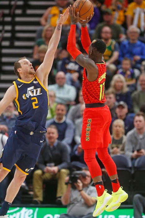 Atlanta Hawks guard Dennis Schroder (17) shoots as Utah Jazz forward Joe Ingles (2) defends in the first half during an NBA basketball game Tuesday, March 20, 2018, in Salt Lake City. (AP Photo/Rick Bowmer)