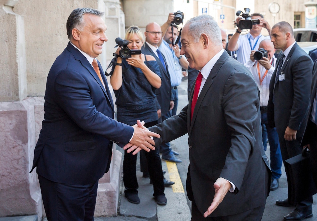 Hungarian Prime Minister Viktor Orban, left, shake hands with Israel's  Prime Minister Benjamin Netanyahu prior to meeting of Netanyahu and the Visegrad Group's (V4) Prime Ministers in the Pesti Vigado building in Budapest, Hungary, Wednesday, July 19, 2017. Netanyahu is staying on a four-day official visit in Hungary. (Balazs Mohai/MTI via AP)
