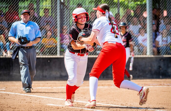 (Isaac Hale | Special to The Tribune) Mountain Ridge first baseman Brynnlee Murdock (23) tags out Spanish Fork second baseman J'Amy Davis (12) during the second game of a best-of-three series between the Spanish Fork Lady Dons and the Mountain Ridge Sentinels as part of the 5A state softball championship held at the Spanish Fork Sports Park on Friday, May 28, 2021.