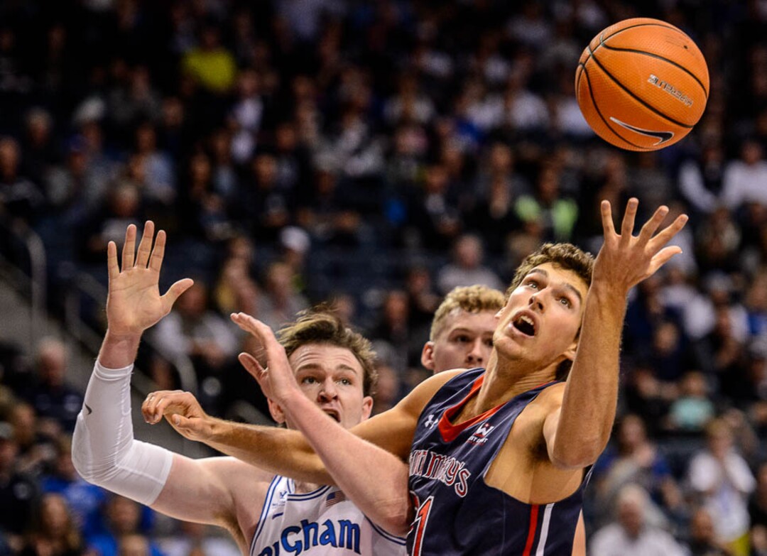 (Trent Nelson | The Salt Lake Tribune)   Brigham Young Cougars forward Payton Dastrup (15) and St. Mary's Gaels center Evan Fitzner (21) look for the rebound as BYU hosts the St. Mary's Gaels, NCAA basketball in Provo, Saturday December 30, 2017.