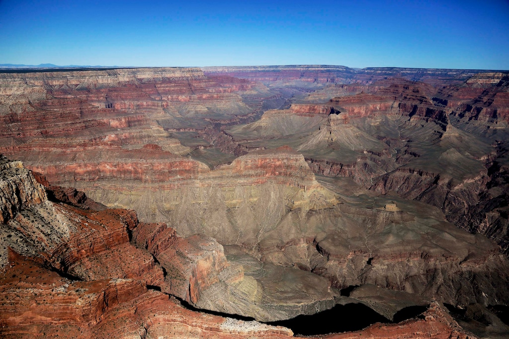 (Julie Jacobson | Associated Press file photo) In this Oct. 5, 2013, file photo, the Grand Canyon National Park is covered in the morning sunlight as seen from a helicopter near Tusayan, Ariz. Police on Saturday said a helicopter has crashed at the Grand Canyon, killing three people.