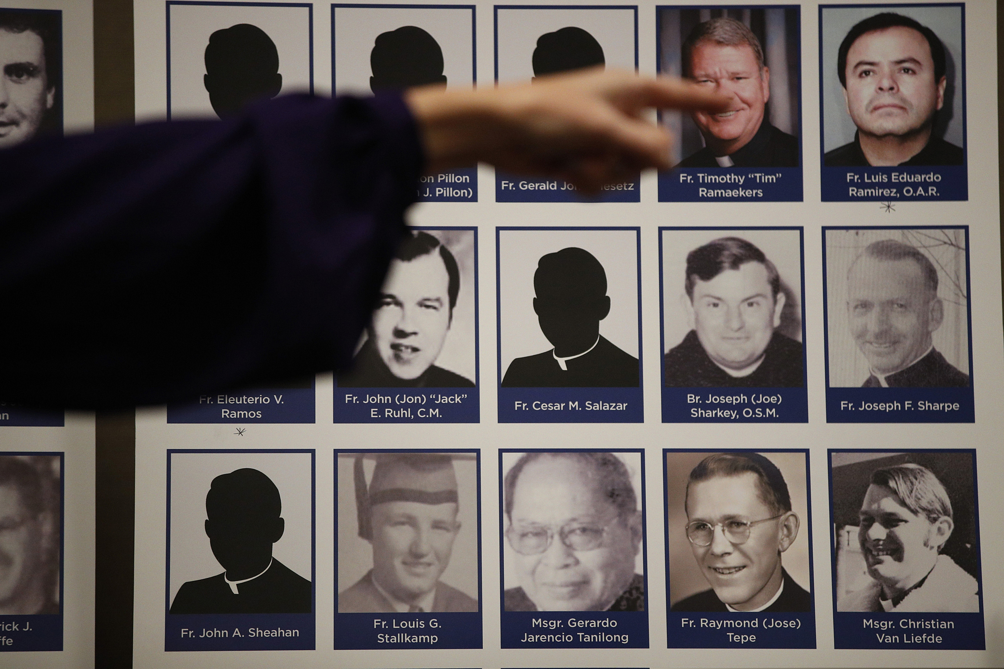 (AP Photo/Jae C. Hong) In this Thursday, Dec. 6, 2018, photo, a sexual abuse victim points to the photos of Catholic priests accused of sexual misconduct by victims during a news conference in Orange, Calif. On Friday, May 31, 2019, the U.S. Catholic Church says that allegations of child sex-abuse by clergy more than doubled in its latest 12-month reporting period, and its spending on victim compensation and child protection surged above $300 million. During the period between July 1, 2017, and June 30, 2018, 1,385 adults came forward with 1,455 allegations of abuse, according to the annual report of the U.S. Conference of Catholic Bishops' Secretariat of Child and Youth Protection. That was up from 693 allegations in the previous year.