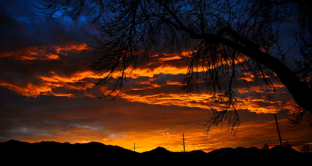(Steve Griffin  |  The Salt Lake Tribune) The morning sky glows orange as the sunrises over the Wasatch Mountains in Salt Lake City Monday November 27, 2017.