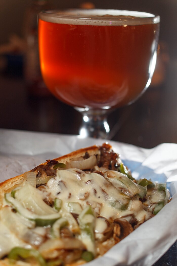 (Trent Nelson  |  Tribune File Photo)  The Philly Cheesesteak sandwich with a schooner of beer at Spedelli's in Salt Lake City.