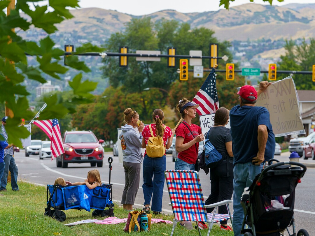 (Leah Hogsten | The Salt Lake Tribune) Protesters waving American flags and holding signs decrying mask and vaccine mandates gathered along the curb of 700 East in Liberty Park Saturday, making Salt Lake City one of dozens of cities around the world protesting public health-related restrictions, Sept. 18, 2021.