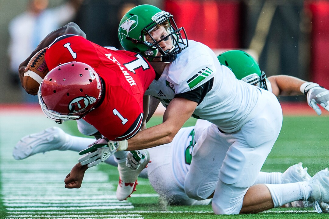 (Chris Detrick  |  The Salt Lake Tribune)  Utah Utes quarterback Tyler Huntley (1) is tackled by North Dakota Fighting Hawks defensive back Evan Holm (6) during the game at Rice-Eccles Stadium Thursday, August 31, 2017. Utah Utes are leading North Dakota Fighting Hawks 17-9 at halftime. 