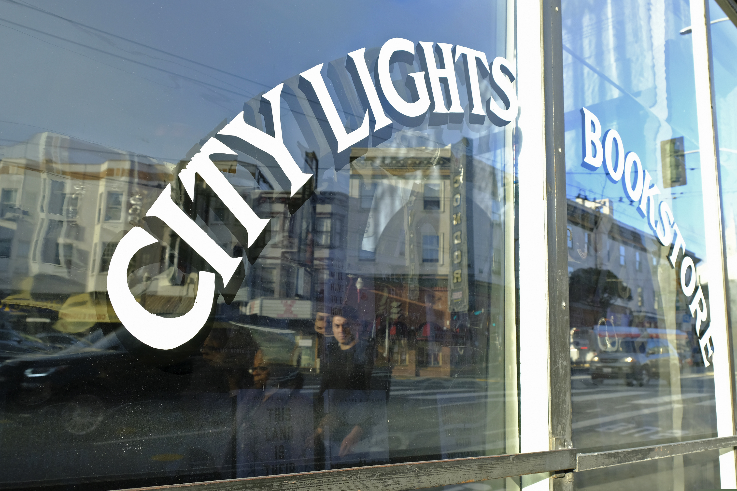 (Eric Risberg | AP file photo)

In this March 13 photo, people are reflected in the window of the City Lights Bookstore in North Beach as they walk along Columbus Avenue in San Francisco. The famous independent bookseller was in dire financial shape because of the coronavirus outbreak and asked for help. Within days of starting a GoFundMe campaign last week seeking $300,000, the store received more than $400,000, from thousands of contributors.