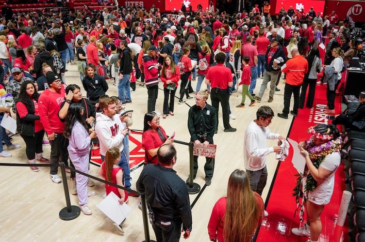 (Bethany Baker | The Salt Lake Tribune) Utah Utes forward Alissa Pili (35) signs a poster for a fan following the game at Jon M. Huntsman Center in Salt Lake City on Saturday, March 2, 2024.