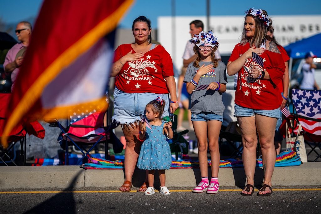 (Trent Nelson  |  The Salt Lake Tribune) Spectators stand for the flag at the Murray City Fun Days Parade on Tuesday, June 30, 2026