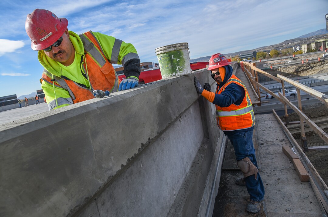 (Francisco Kjolseth  |  The Salt Lake Tribune)  Miguel Jimenez, left, and Manuel Robles do patchwork as UDOT completes the first stage of the new Triumph Blvd bridge in Lehi, opening East to West traffic on Thursday, Nov. 1, 2018, as part of the I-15 Technology Corridor Project.