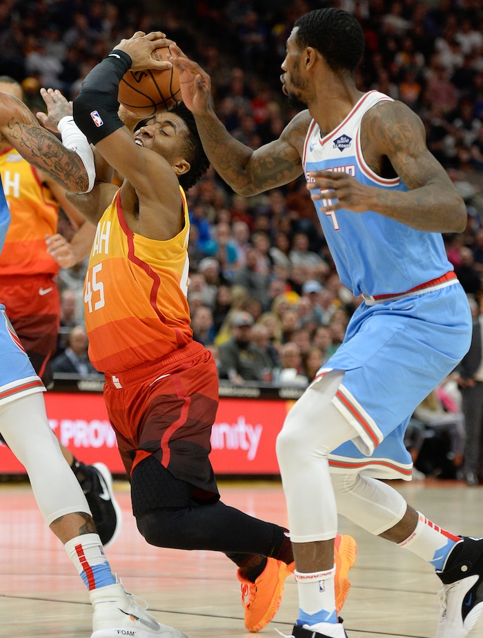 (Francisco Kjolseth  |  The Salt Lake Tribune)  Utah Jazz guard Donovan Mitchell (45) is pressured by Sacramento Kings guard Iman Shumpert (9) in the NBA game at Vivint Smart Home Arena Wed., Nov. 21, 2018, in Salt Lake City.