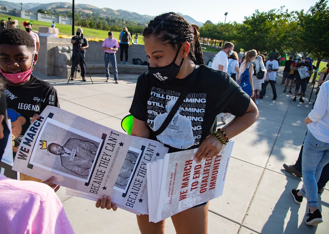 (Francisco Kjolseth  |  The Salt Lake Tribune) Rae Duckworth hands out posters to other Utah activists gathered at Utah's Capitol on Friday, August 28, 2020, to commemorate the 57th anniversary of the March on Washington in D.C. led by Martin Luther King Jr.