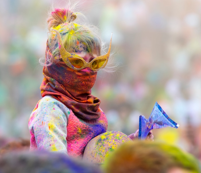 (Rick Egan  |  The Salt Lake Tribune)      Arina Fox, 3, from Provo sits on her dad Tyler's shoulders, during the 22nd annual Holi Festival of Colors at the Sri Sri Radha Krishna Temple in Spanish Fork, Saturday, March 24, 2018. The festival which celebrates the beginning or spring is also known as at the Festival of Love.