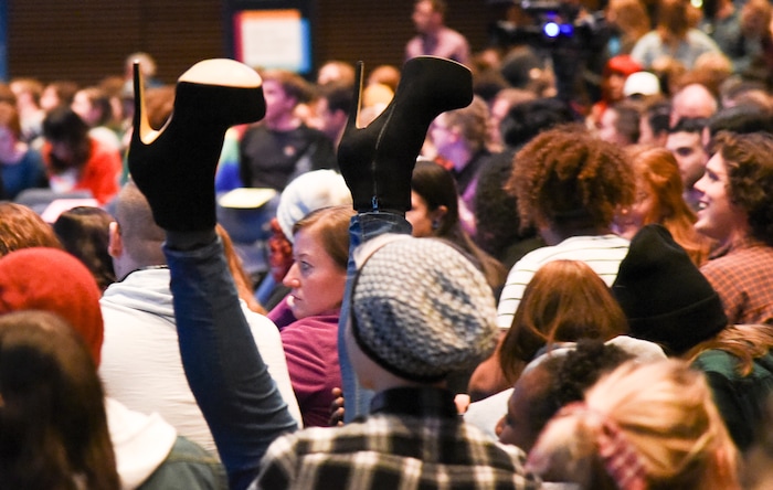 (Francisco Kjolseth  |  The Salt Lake Tribune)  An audience member kicks his heels into the air as a large crowd awaits the start of Utah State University's very first drag queen show recently. 
