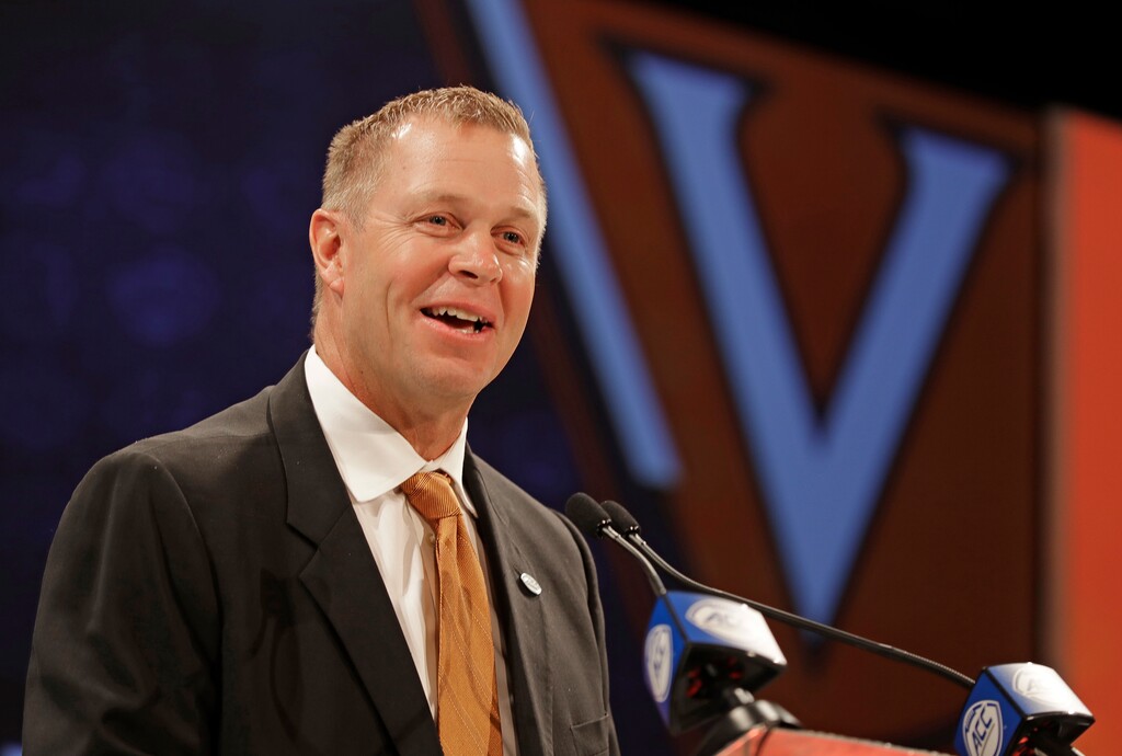 RETRANSMISSION TO CORRECT SCHOOL TO VIRGINIA - Virginia head coach Bronco Mendenhall answers a question during a news conference at the NCAA Atlantic Coast Conference college football media day in Charlotte, N.C., Wednesday, July 18, 2018. (AP Photo/Chuck Burton)