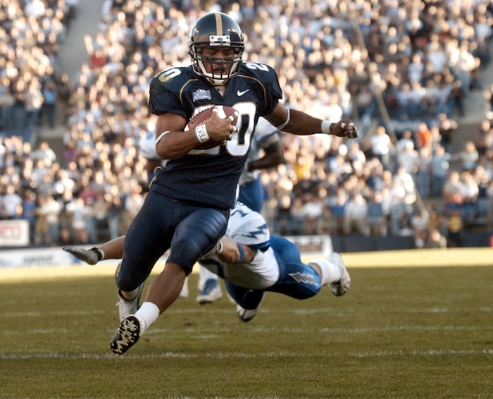 (Rick Egan  |  Tribune File Photo)  BYU's Reno Mahe runs for a touchdown as Air Force's Adam Hanes make's a desperate dive for a tackle on October 20, 2001.