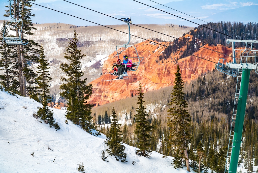 (Brian Head Resort) Skiers ride past red cliffs at Brian Head Resort near Cedar City. Brian Head has set its tentative opening date as Nov. 8, which would be its second earliest on record.