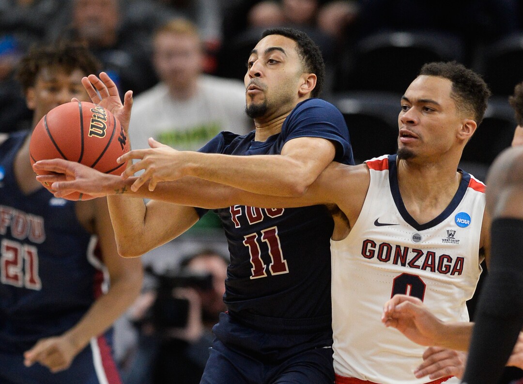 (Francisco Kjolseth  |  The Salt Lake Tribune)  Fairleigh Dickinson Knights guard Tyler Jones (11) battles for the ball against Gonzaga Bulldogs guard Geno Crandall (0) as Gonzaga faces Fairleigh Dickinson in their first round menÕs NCAA March Madness tournament game at Vivint Smart Home Arena in Salt Lake City on Thursday, March 21, 2019.