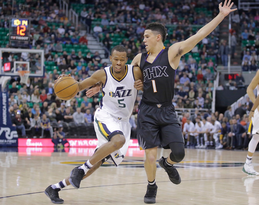 Phoenix Suns guard Devin Booker (1) guards Utah Jazz guard Rodney Hood (5) in the first half during an NBA basketball game Saturday, Dec. 31, 2016, in Salt Lake City. (AP Photo/Rick Bowmer)