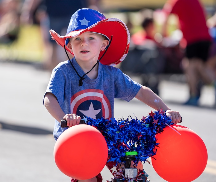 (Rick Egan | The Salt Lake Tribune)  Kids ride down 2600 North in the Kids Bike Parade, before the Cherry Days Fourth of July celebration, in North Ogden, on Monday, July 4, 2022.