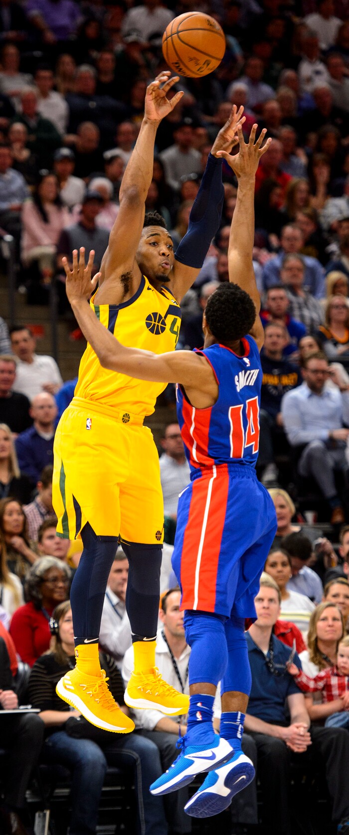 (Steve Griffin  |  The Salt Lake Tribune)  Utah Jazz guard Donovan Mitchell (45) fires a pass over Detroit Pistons guard Ish Smith (14) during the Utah Jazz versus Detroit Pistons at Vivint Smart Home Arena in Salt Lake City Tuesday March 13, 2018.